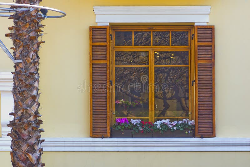 Decorated window with external reflection at Rothschild avenue in the city of Tel Aviv Israel in sunny summer morning. Decorated window with external reflection at Rothschild avenue in the city of Tel Aviv Israel in sunny summer morning