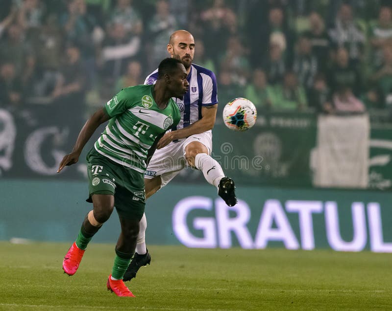 Branko Pauljevic of Ujpest FC competes for the ball with Tokmac