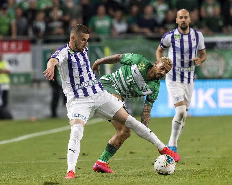 Branko Pauljevic of Ujpest FC competes for the ball with Tokmac