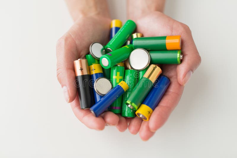 Fermez-vous des mains tenant le tas d'accumulateurs alcalins photographie stock libre de droits Fermez-vous des mains tenant le tas d'accumulateurs alcalins photographie stock libre de droits