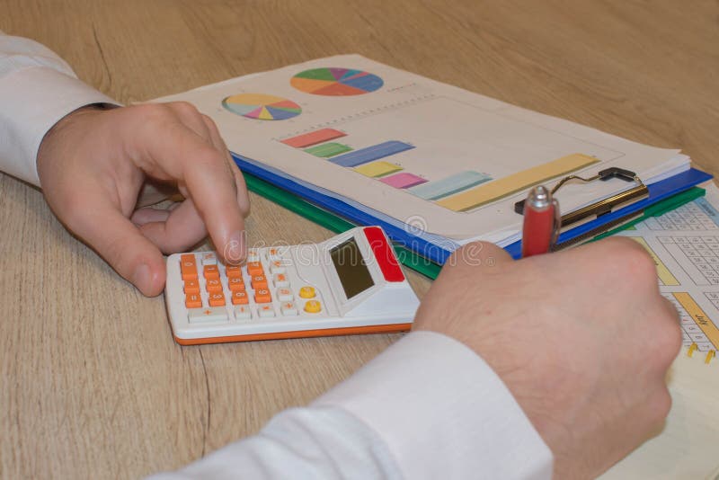 Fermez-vous vers le haut de la vue du comptable ou des mains financi?res d'inspecteur r?digeant le rapport, calculant ou v?rifian image libre de droits Fermez-vous vers le haut de la vue du comptable ou des mains financi?res d'inspecteur r?digeant le rapport, calculant ou v?rifian image libre de droits