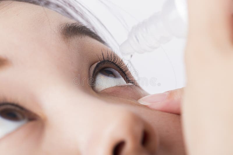 Fermez-vous vers le haut des égouttements dans le médicament de cataracte d'oeil photographie stock Fermez-vous vers le haut des égouttements dans le médicament de cataracte d'oeil photographie stock
