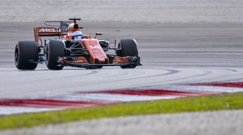 SEPANG, MALAYSIA - SEPTEMBER 30, 2017 : Fernando Alonso of Spain driving the 14 McLaren Honda Formula 1 Team on track during the Malaysia Formula One F1 Grand Prix at Sepang International Circuit. SEPANG, MALAYSIA - SEPTEMBER 30, 2017 : Fernando Alonso of Spain driving the 14 McLaren Honda Formula 1 Team on track during the Malaysia Formula One F1 Grand Prix at Sepang International Circuit