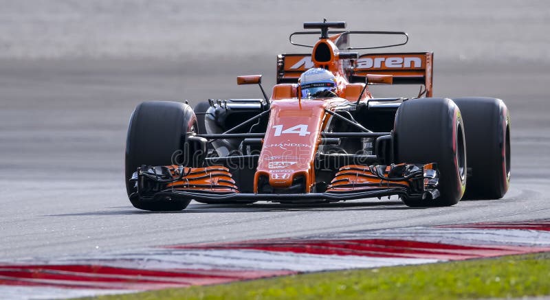 SEPANG, MALAYSIA - SEPTEMBER 30, 2017 : Fernando Alonso of Spain driving the 14 McLaren Honda Formula 1 Team on track during the Malaysia Formula One F1 Grand Prix at Sepang International Circuit. SEPANG, MALAYSIA - SEPTEMBER 30, 2017 : Fernando Alonso of Spain driving the 14 McLaren Honda Formula 1 Team on track during the Malaysia Formula One F1 Grand Prix at Sepang International Circuit