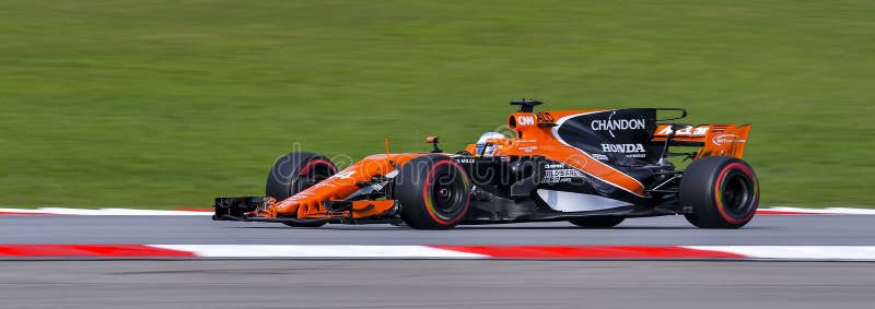 SEPANG, MALAYSIA - SEPTEMBER 30, 2017 : Fernando Alonso of Spain driving the 14 McLaren Honda Formula 1 Team on track during the Malaysia Formula One F1 Grand Prix at Sepang International Circuit. SEPANG, MALAYSIA - SEPTEMBER 30, 2017 : Fernando Alonso of Spain driving the 14 McLaren Honda Formula 1 Team on track during the Malaysia Formula One F1 Grand Prix at Sepang International Circuit