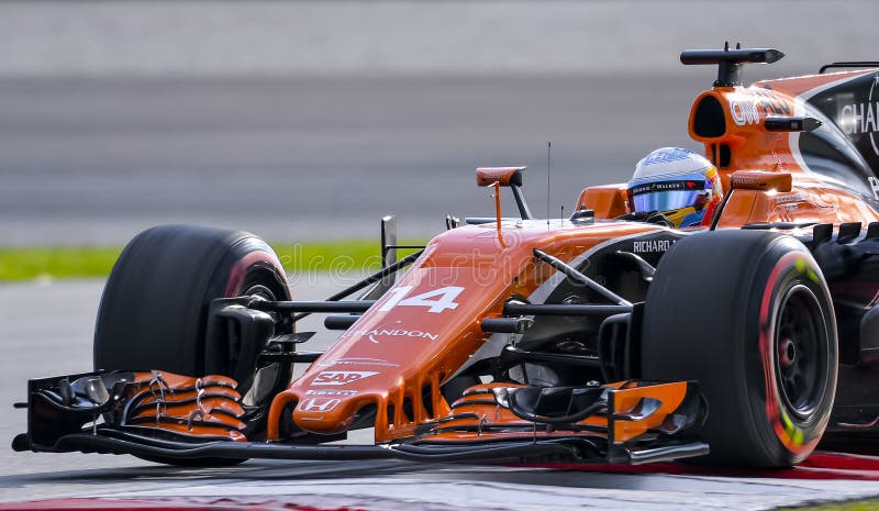 SEPANG, MALAYSIA - SEPTEMBER 30, 2017 : Fernando Alonso of Spain driving the 14 McLaren Honda Formula 1 Team on track during the Malaysia Formula One F1 Grand Prix at Sepang International Circuit. SEPANG, MALAYSIA - SEPTEMBER 30, 2017 : Fernando Alonso of Spain driving the 14 McLaren Honda Formula 1 Team on track during the Malaysia Formula One F1 Grand Prix at Sepang International Circuit