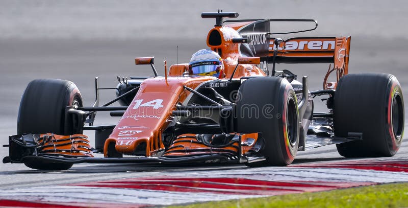 SEPANG, MALAYSIA - SEPTEMBER 30, 2017 : Fernando Alonso of Spain driving the 14 McLaren Honda Formula 1 Team on track during the Malaysia Formula One F1 Grand Prix at Sepang International Circuit. SEPANG, MALAYSIA - SEPTEMBER 30, 2017 : Fernando Alonso of Spain driving the 14 McLaren Honda Formula 1 Team on track during the Malaysia Formula One F1 Grand Prix at Sepang International Circuit