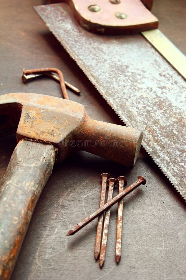 Old hammer, hand saw and nails. Old hammer, hand saw and nails