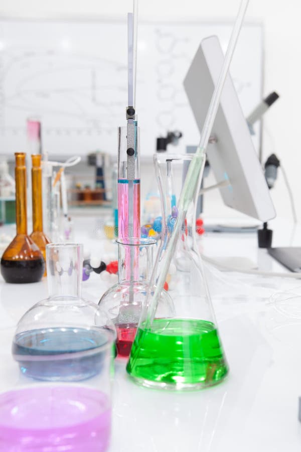 Close-up of laboratory tools and colorful liquids on a lab table. Close-up of laboratory tools and colorful liquids on a lab table