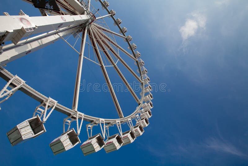 Ferris or observation big wheel against blue sky