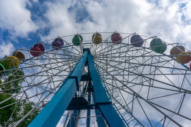 Ferris wheel against the blue sky with white clouds in the park stock photos