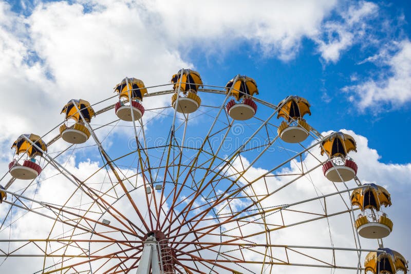 Ferris wheel against the sky. Attraction in the city Park