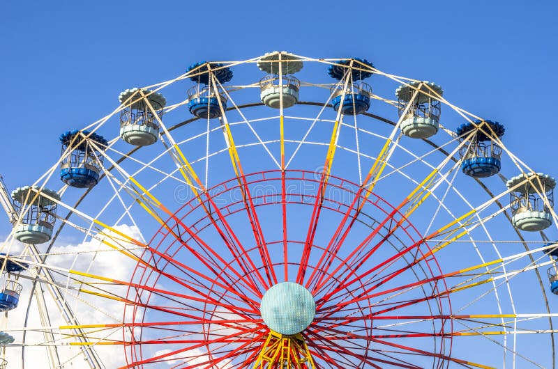 Ferris wheel on white on blue skype and cloud.