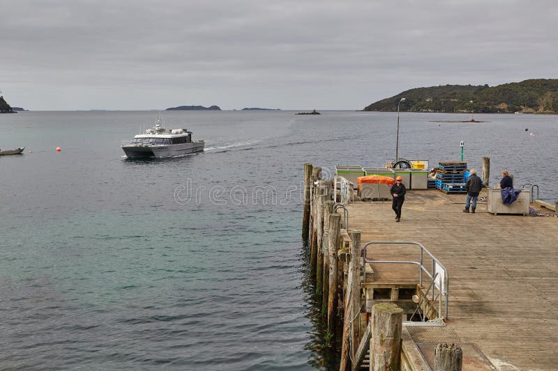 Oban, New Zealand - March 16, 2016: Harbor of Oban, New Zealand, Ferry from Bluff arriving to the southernmost settlement of the country on Rakiura Stewart Island. Oban, New Zealand - March 16, 2016: Harbor of Oban, New Zealand, Ferry from Bluff arriving to the southernmost settlement of the country on Rakiura Stewart Island