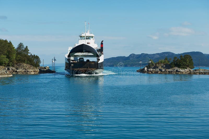 Ferry boat arrives to the port in Tveit, Norway.