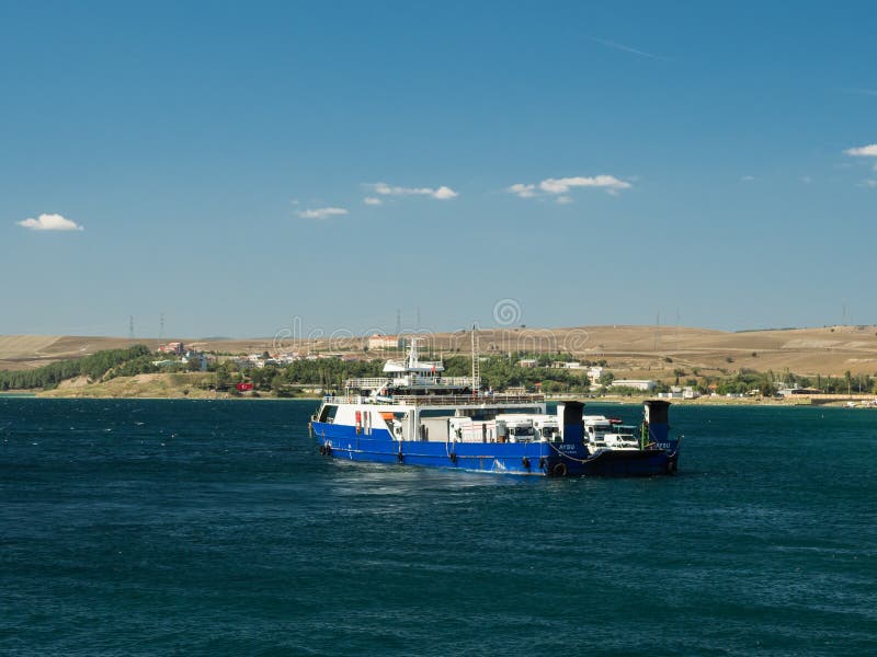 Canakkale, Turkey - October 05, 2018: The ferry with trucks, cars and passengers on board crossing Dardanelles Strait in Canakkale, Turkey. Canakkale, Turkey - October 05, 2018: The ferry with trucks, cars and passengers on board crossing Dardanelles Strait in Canakkale, Turkey