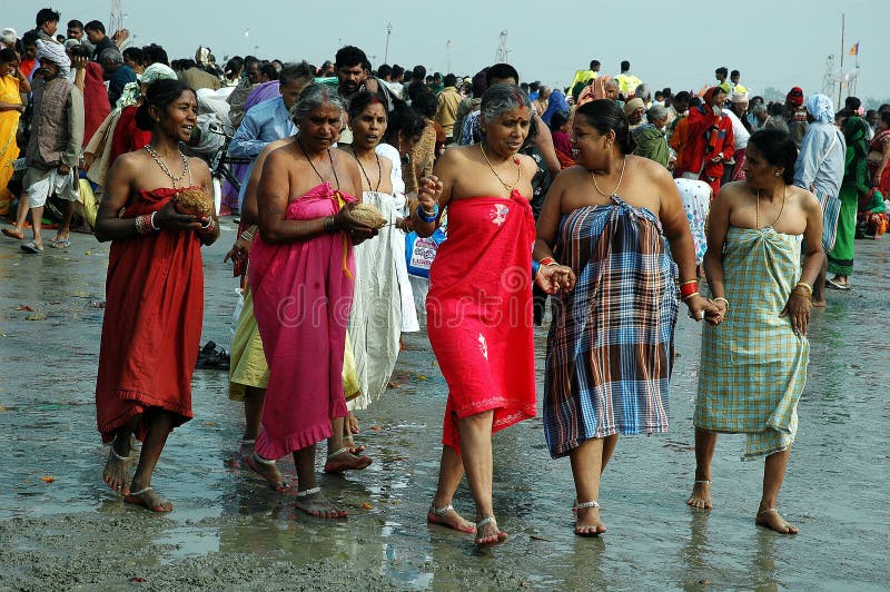 January 14, 2009-Ganga sagar, West Bengal, India -WOMEN GOING FOR HOLY BATH. Gangasagar Mela is the largest fair, celebrated in West Bengal (INDIA). This fair is held where the Ganga river and the Bay of Bengal form a nexus. Hence the name Gangasagar Mela. This festival is celebrated during mid January every year and is a major attraction for millions of pilgrims from different parts of the country gather at Gangasagar, the point where the holy river Ganges meets the sea to take a dip and wash away all the earthly sins. January 14, 2009-Ganga sagar, West Bengal, India -WOMEN GOING FOR HOLY BATH. Gangasagar Mela is the largest fair, celebrated in West Bengal (INDIA). This fair is held where the Ganga river and the Bay of Bengal form a nexus. Hence the name Gangasagar Mela. This festival is celebrated during mid January every year and is a major attraction for millions of pilgrims from different parts of the country gather at Gangasagar, the point where the holy river Ganges meets the sea to take a dip and wash away all the earthly sins.