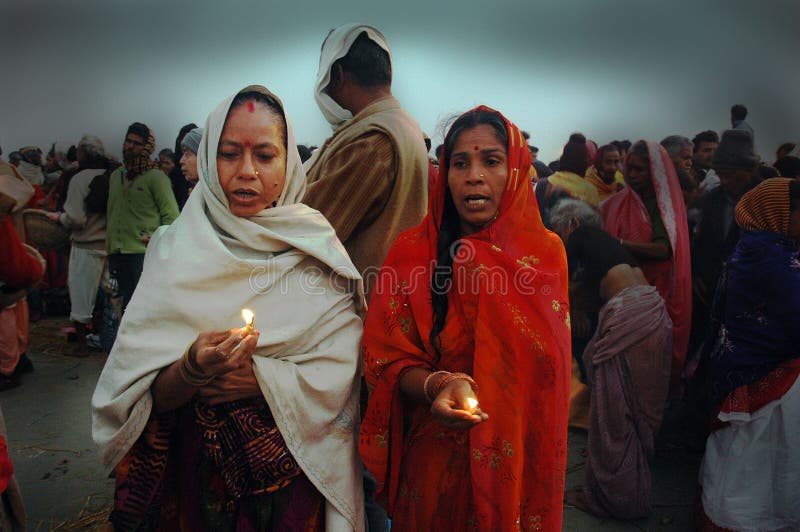 January 14, 2009-Ganga sagar, West Bengal, India -TWO WOMAN PRAYING TO THE SUN GOD WITH CANDLE LIGHT. Gangasagar Mela is the largest fair, celebrated in West Bengal (INDIA). This fair is held where the Ganga river and the Bay of Bengal form a nexus. Hence the name Gangasagar Mela. This festival is celebrated during mid January every year and is a major attraction for millions of pilgrims from different parts of the country gather at Gangasagar, the point where the holy river Ganges meets the sea to take a dip and wash away all the earthly sins. January 14, 2009-Ganga sagar, West Bengal, India -TWO WOMAN PRAYING TO THE SUN GOD WITH CANDLE LIGHT. Gangasagar Mela is the largest fair, celebrated in West Bengal (INDIA). This fair is held where the Ganga river and the Bay of Bengal form a nexus. Hence the name Gangasagar Mela. This festival is celebrated during mid January every year and is a major attraction for millions of pilgrims from different parts of the country gather at Gangasagar, the point where the holy river Ganges meets the sea to take a dip and wash away all the earthly sins.