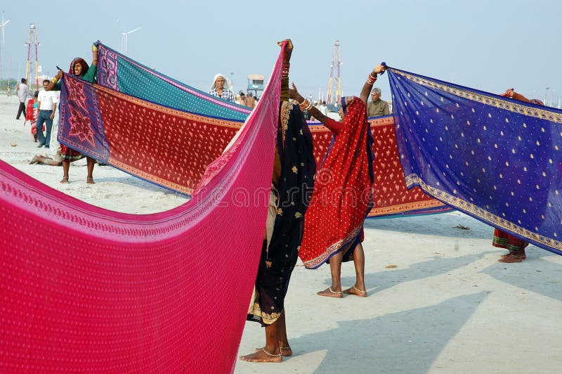 January 14, 2009-Ganga sagar, West Bengal, India - WOMEN ARE DRYING THEIR CLOTH AFTER THE HOLY BATH. Gangasagar Mela is the largest fair, celebrated in West Bengal (INDIA). This fair is held where the Ganga river and the Bay of Bengal form a nexus. Hence the name Gangasagar Mela. This festival is celebrated during mid January every year and is a major attraction for millions of pilgrims from different parts of the country gather at Gangasagar, the point where the holy river Ganges meets the sea to take a dip and wash away all the earthly sins. January 14, 2009-Ganga sagar, West Bengal, India - WOMEN ARE DRYING THEIR CLOTH AFTER THE HOLY BATH. Gangasagar Mela is the largest fair, celebrated in West Bengal (INDIA). This fair is held where the Ganga river and the Bay of Bengal form a nexus. Hence the name Gangasagar Mela. This festival is celebrated during mid January every year and is a major attraction for millions of pilgrims from different parts of the country gather at Gangasagar, the point where the holy river Ganges meets the sea to take a dip and wash away all the earthly sins