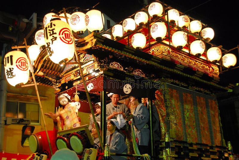 Festival float with musicians and daemon at night
