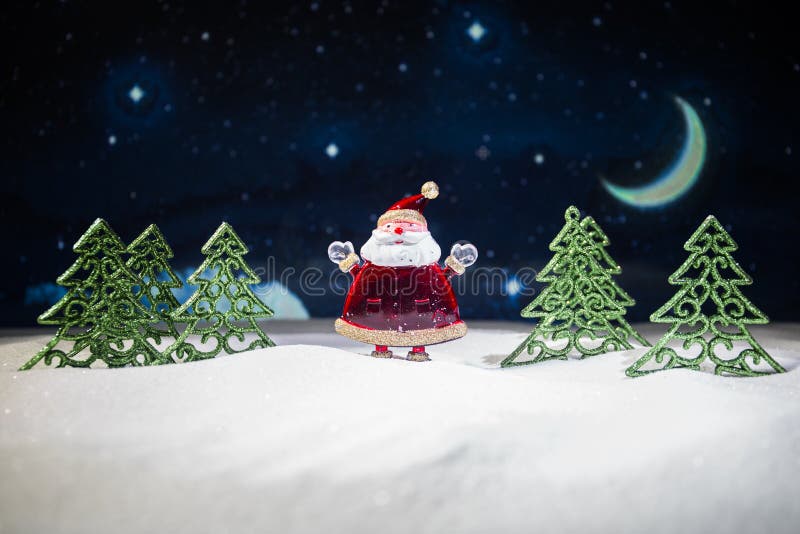 festive background. snowman dressed as Santa Claus with Christmas balls on light background photo has an empty space for your text