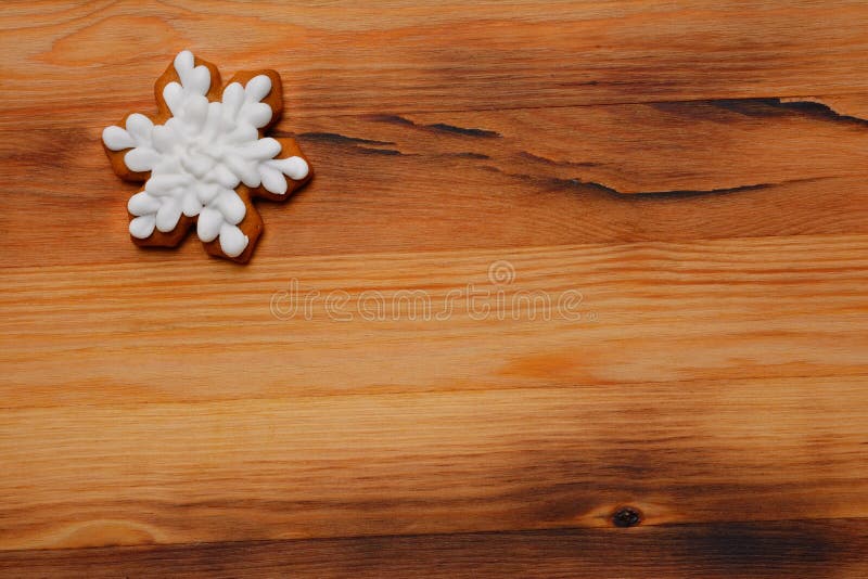 Festive Christmas gingerbread in the shape of a snowflake on a wooden background royalty free stock image Festive Christmas gingerbread in the shape of a snowflake on a wooden background royalty free stock image