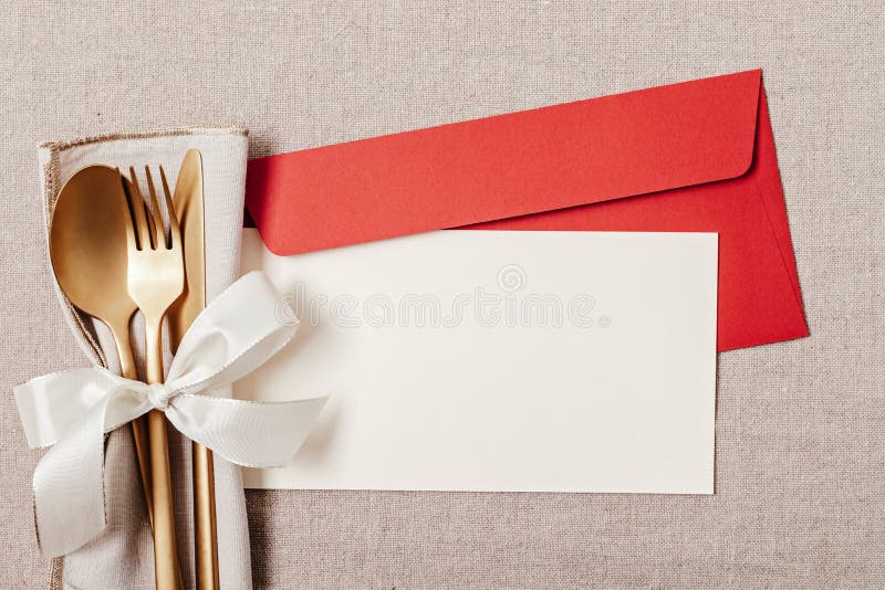 Festive christmas, wedding, birthday table setting with golden cutlery. Mockup for place card, dinner invitation