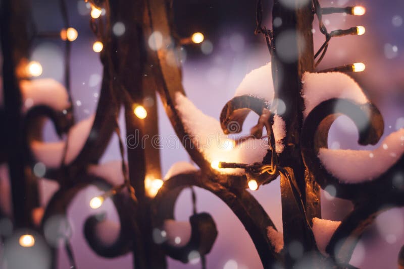 Festive illumination on the fence in the evening winter time, ab royalty free stock image Festive illumination on the fence in the evening winter time, ab royalty free stock image