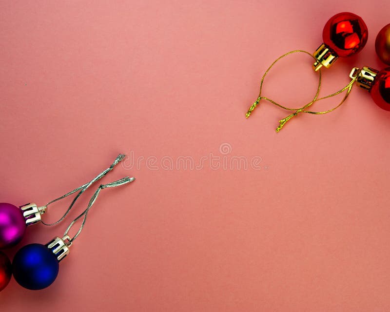 Festive Multicolored Decorative Balls on a Pink Background Stock Photo