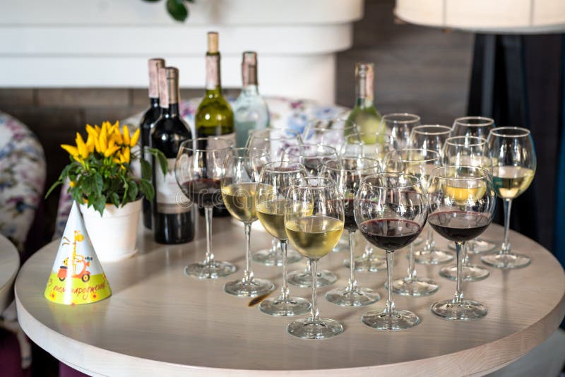 Festive Table with Glasses of Wine, Chilled Bottles of Wine Stock Photo
