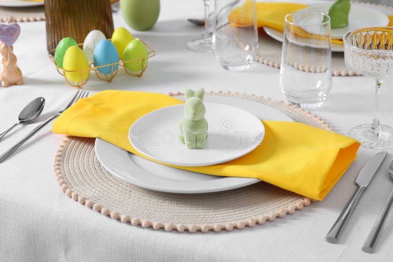Festive Table Setting with Cutlery, Plate and Bunny Figure. Easter