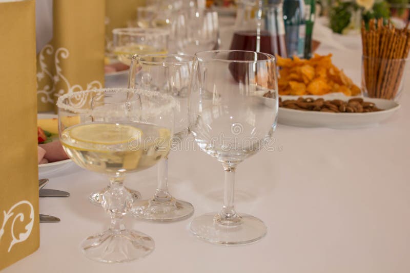 Festive Celebration and Wedding White Dinning Table Setting with Starter, Toast Wine and Two Empty Glasses