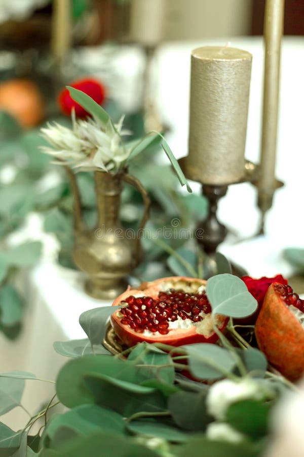Festively decorated banquet table in the restaurant. Fresh flowers are golden candles and red chairs and garnet. expensively rich royalty free stock photo Festively decorated banquet table in the restaurant. Fresh flowers are golden candles and red chairs and garnet. expensively rich royalty free stock photo