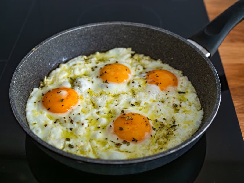 Feta fried eggs in frying pan on electric stove. Frying pan stock images, royalty-free photos and pictures