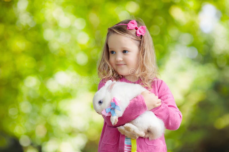 Fetiță care se joacă cu iepurele royalty free stock photography