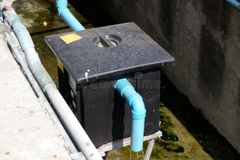 Outdoor grease trap tank, outside a restaurant. Outdoor grease trap tank, outside a restaurant