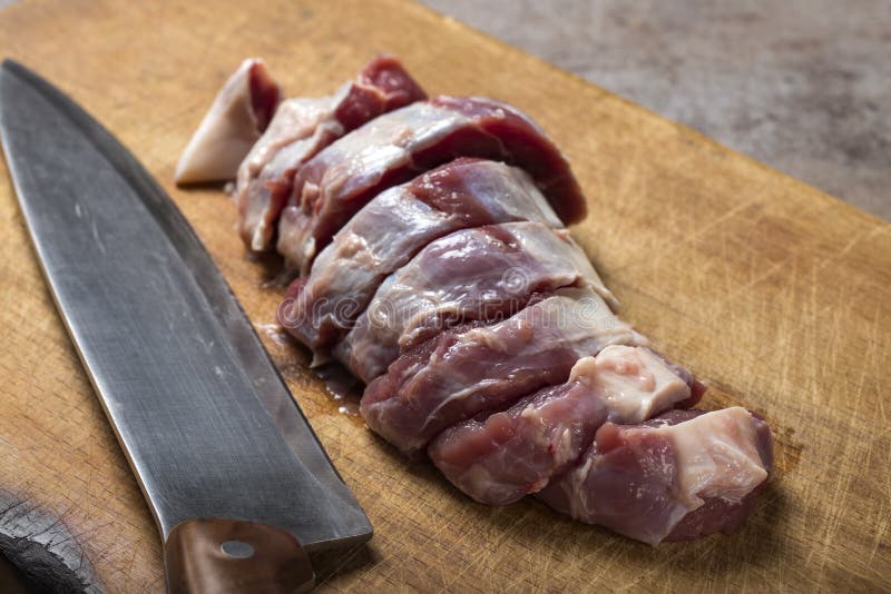 Fette di carne cruda del manzo su un tagliere di legno fotografia stock libera da diritti Fette di carne cruda del manzo su un tagliere di legno fotografia stock libera da diritti