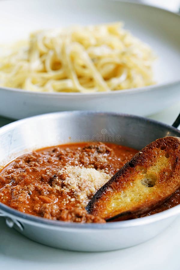 Fettuccine Bolognese Served with a Big Toast Topped with Grated Cheese ...