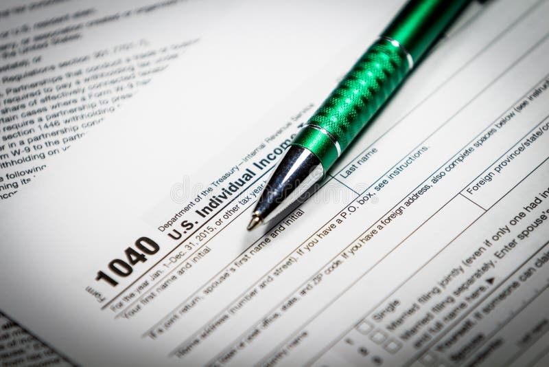 US tax form 1040 with pen and calculator. Tax form law document, business concept. US tax form 1040 with pen and calculator. Tax form law document, business concept