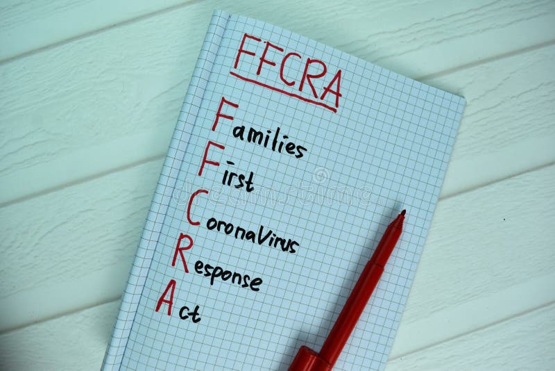 FFCRA - Families First Coronavirus Response Act write on a book isolated on office desk