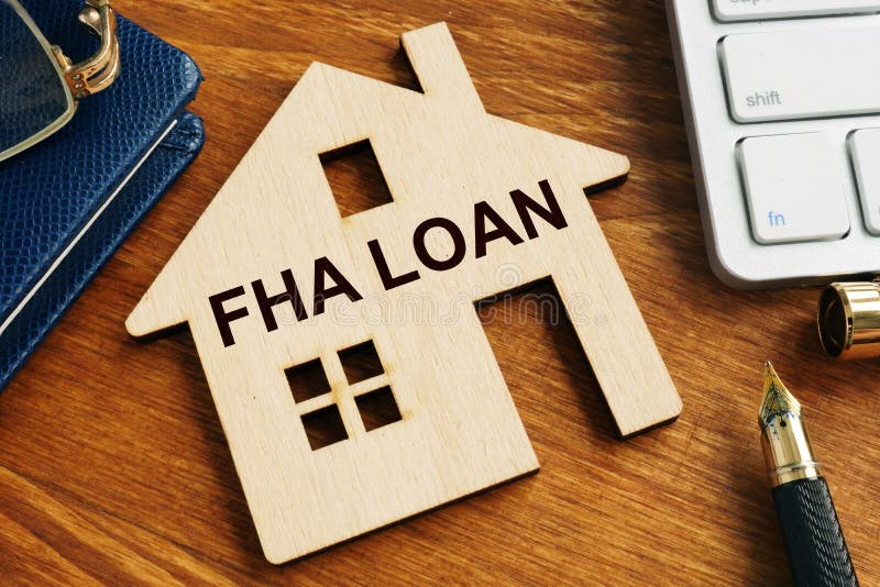 FHA loan written on the wooden model of home. FHA loan written on the wooden model of home