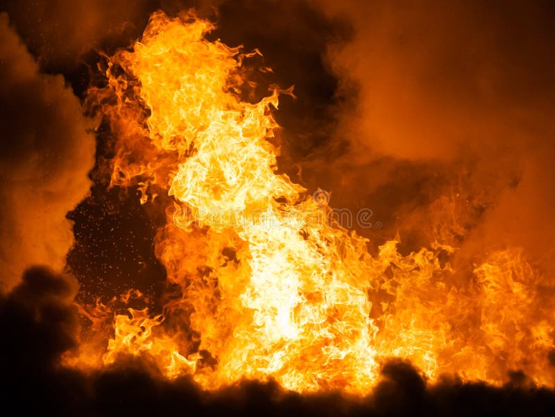 Arson or nature disaster - burning fire flame on wooden house roof. Arson or nature disaster - burning fire flame on wooden house roof