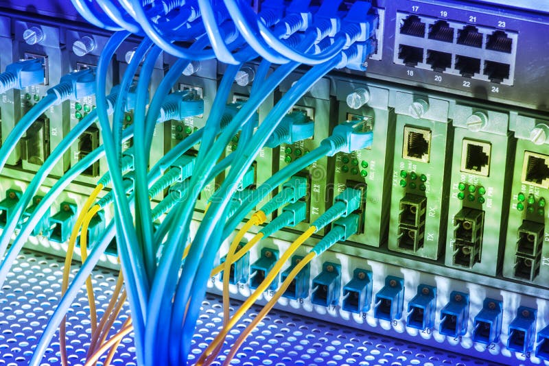Fiber Optic Cables and UTP Network Cables Connected Hub Ports. Stock