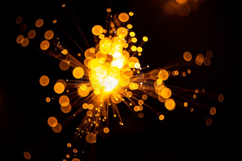 Fiber optic light abstract bokeh background with warm color. Out of focus stock photo