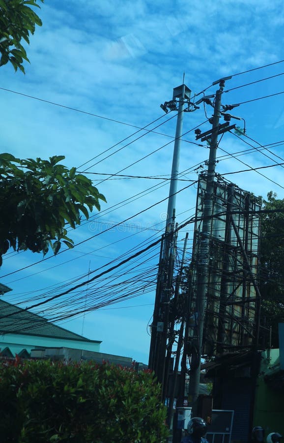 Fiber Optic Network Cable on the Pole. Aerial Fiber Optic Stock Photo