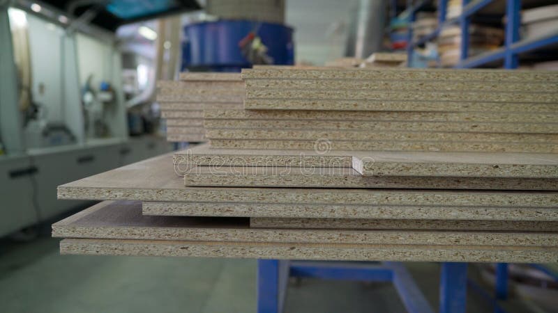 Woodworking industry and furniture assembly concept. Fiberboard at a furniture factory. Boards at the factory close-up. Fragment