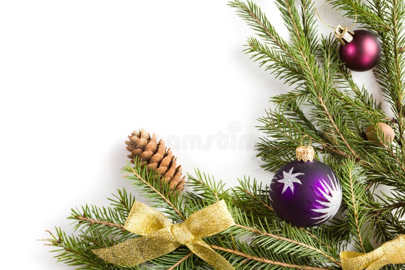 Spruce branches with cones and Christmas decorations on a white background. Space for text. Spruce branches with cones and Christmas decorations on a white background. Space for text.