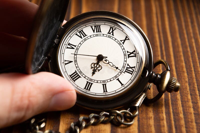 Pocket watch on wooden background closeup. Pocket watch on wooden background closeup