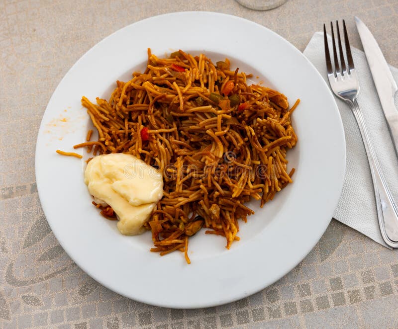 Fideua with seafood served on platter stock photo