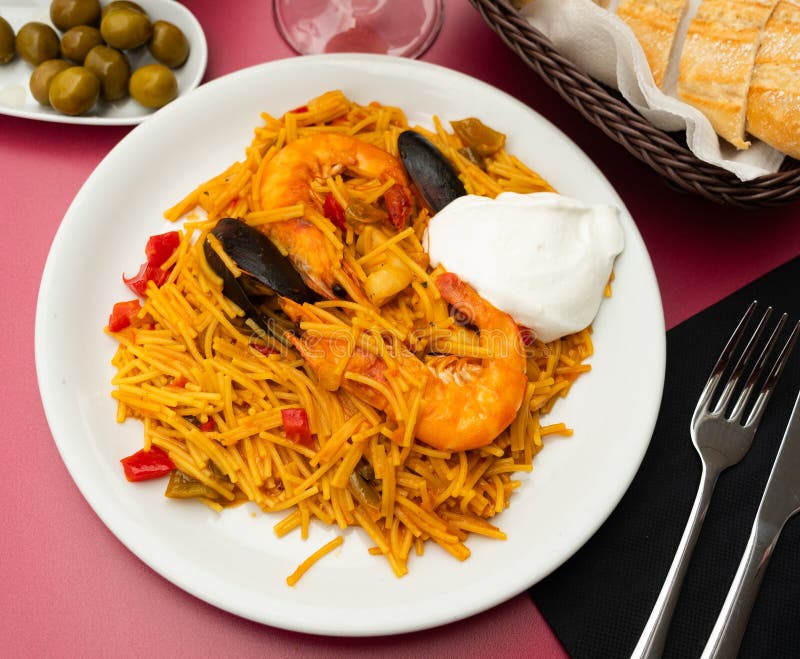 Fideua with seafood served on platter royalty free stock photo
